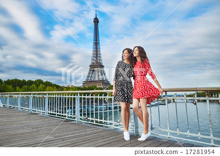 Twin sisters in front of the Eiffel tower in Paris, France Twin sisters in front of the Eiffel tower in Paris, France 17281954