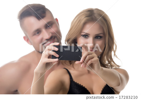 Couple doing selfie. Focus on mobile phone Couple doing selfie. Focus on mobile phone 17283210