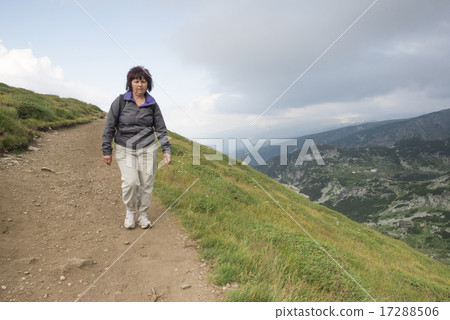 Senior woman walking in the mountain Senior woman walking in the mountain 17288506