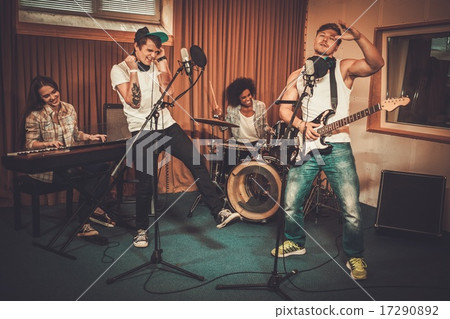 Multiracial music band performing in a recording studio Multiracial music band performing in a recording studio 17290892