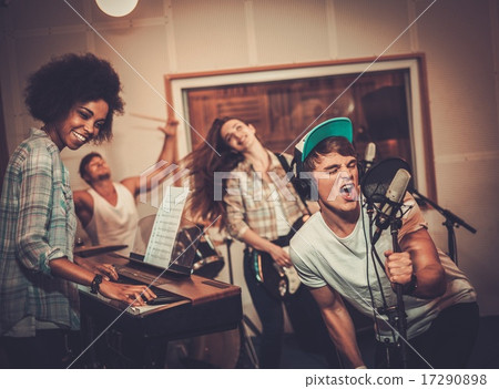 Multiracial music band performing in a recording studio Multiracial music band performing in a recording studio 17290898