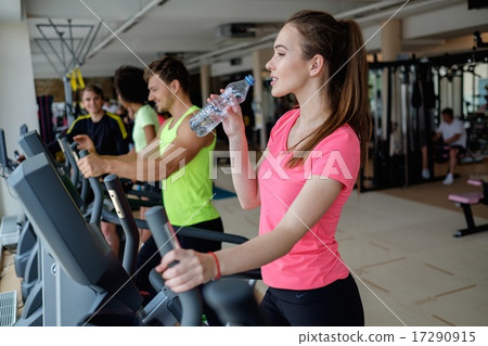 People exercising on a cardio training machines in a gym People exercising on a cardio training machines in a gym 17290915