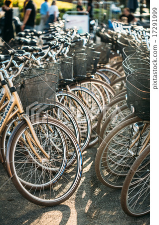 Row of city parked bicycles bikes for rent on sidewalk in Europe 17291999