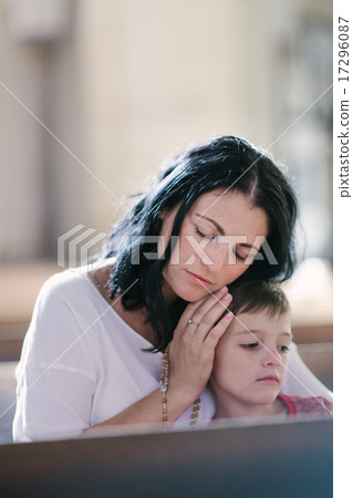 Woman with her son praying Woman with her son praying 17296087