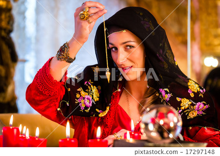 Radiesthesist in Seance dowsing with pendulum 17297148