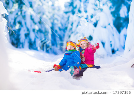 Kids having fun on a sleigh ride in snow 17297396