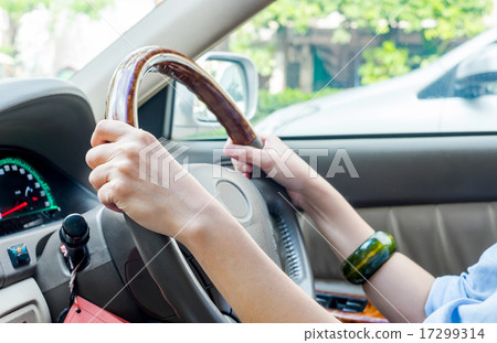 Close up of woman's hands drive a car 17299314