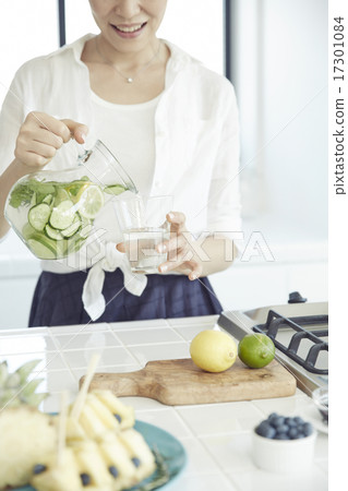 A woman in a bright kitchen A woman in a bright kitchen 17301084