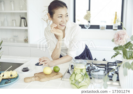 A woman in a bright kitchen A woman in a bright kitchen 17301274