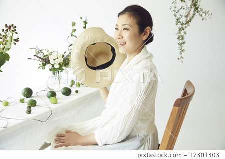 A woman enjoying a flower arrangement 17301303