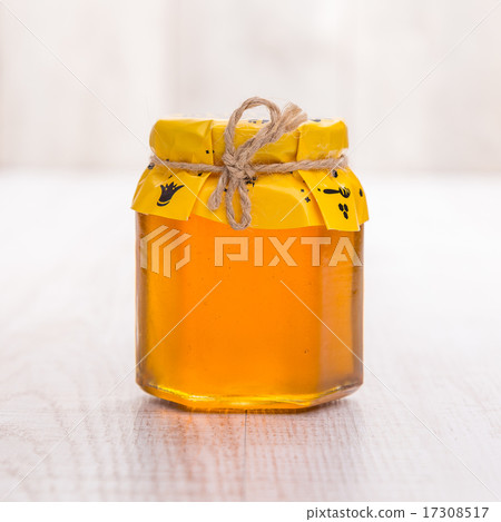 Jar of honey on wooden table Jar of honey on wooden table 17308517