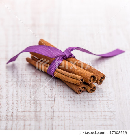 Cinnamon isolated on wooden background 17308519
