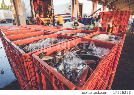 Fish in red basket and defocused of worker 17316258