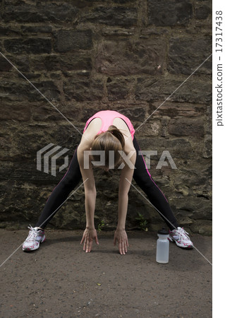 Sporty woman stretching before or after training. Sporty woman stretching before or after training. 17317438
