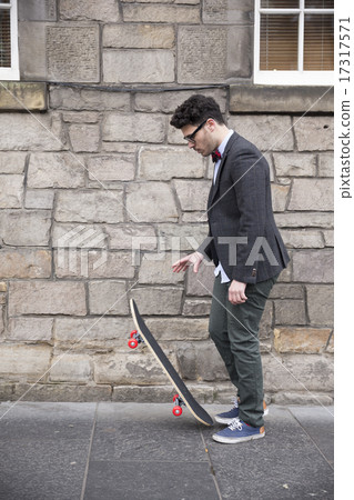 Trendy man holding a skateboard. 17317571