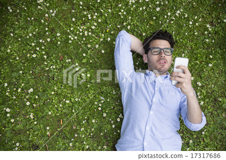 Overhead view of a young man using a Smartphone. 17317686