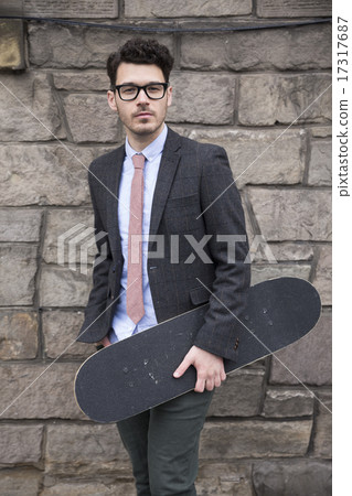 Trendy man holding a skateboard. 17317687