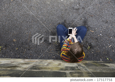 Overhead view of a young woman using a Smartphone. Overhead view of a young woman using a Smartphone. 17317758