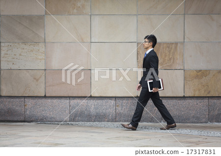 Chinese businessman walking in the city. 17317831