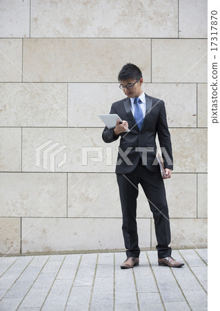Asian business man using digital tablet computer outside. 17317870