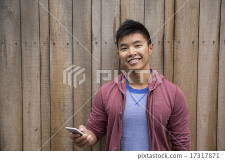Asian Man using Smart Phone outdoors. 17317871