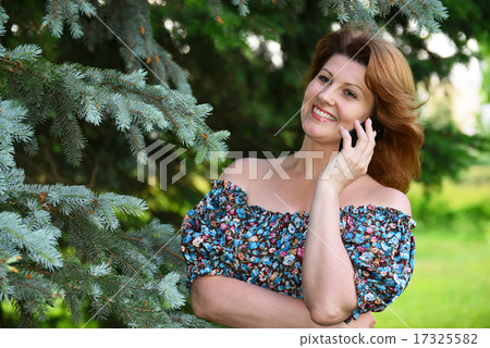 Woman talking on cell phone in the park 17325582