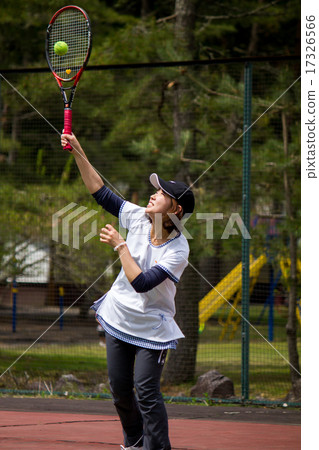 A woman playing tennis A woman playing tennis 17326566
