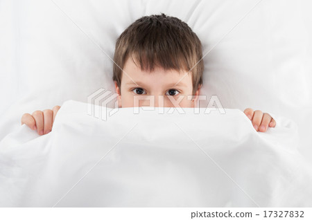 cheerful boy in white bed 17327832