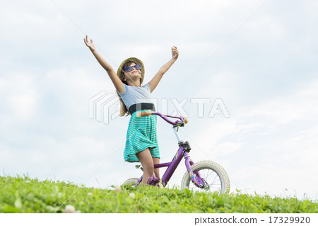 Beautiful portrait of a little girl outside on grass 17329920