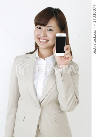 A woman showing a smartphone 17330077