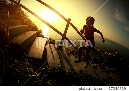 woman runner trail running on seaside mountain woman runner trail running on seaside mountain 17330889