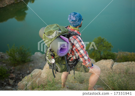 Young caucasian man with backpack on the top of hill 17331941