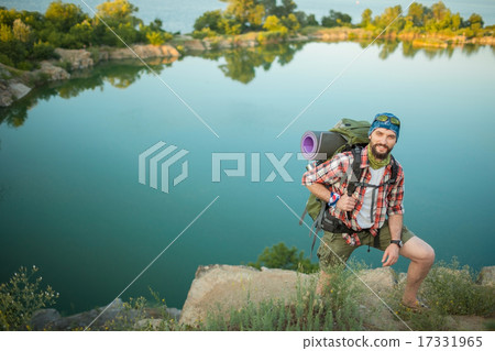 Young caucasian man with backpack climbing the rock Young caucasian man with backpack climbing the rock 17331965