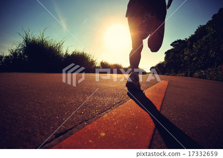 young woman running on sunrise seaside trail 17332659