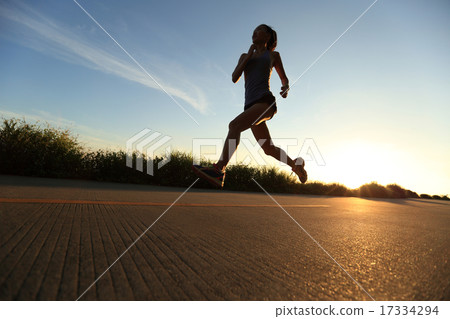 young fitness woman legs running sunrise seaside 17334294