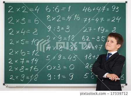 school boy solve math on board 17339712