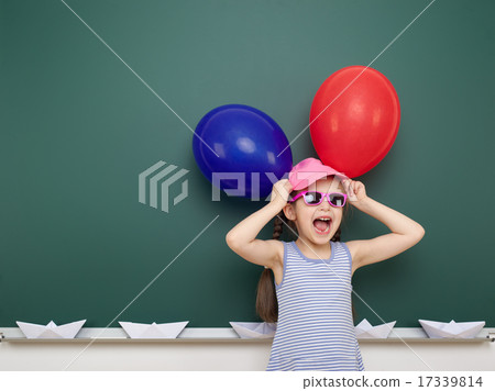 girl with balloon near school board girl with balloon near school board 17339814