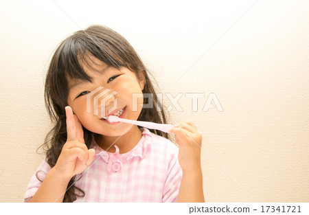 A girl brushing with a smile 17341721