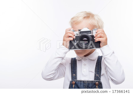 Pretty male child is making photos with joy 17366141