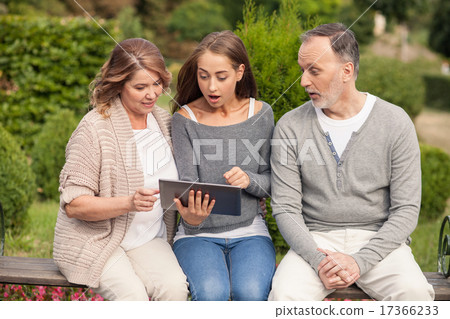 Pretty friendly family is using laptop for fun Pretty friendly family is using laptop for fun 17366233