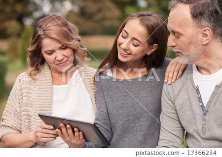 Cute mature family are watching a laptop Cute mature family are watching a laptop 17366234