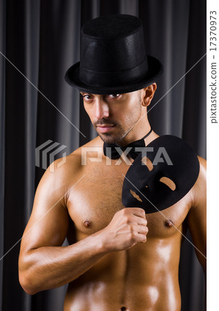 Muscular actor with mask against curtain 17370973