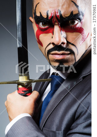 Man with face paint and sword 17370981