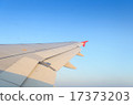 Sun shines on airplane wing on the morning 17373203
