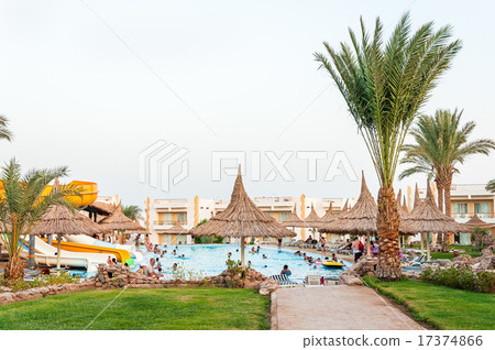 Resort swimming pool in the morning with visitors Resort swimming pool in the morning with visitors 17374866