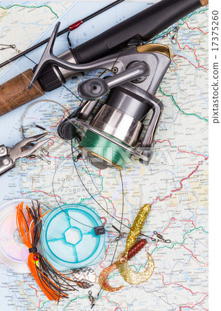 fishing tackles - rod, reel, line and lure on map 17375260