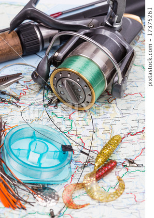 fishing tackles - rod, reel, line and lure on map 17375261