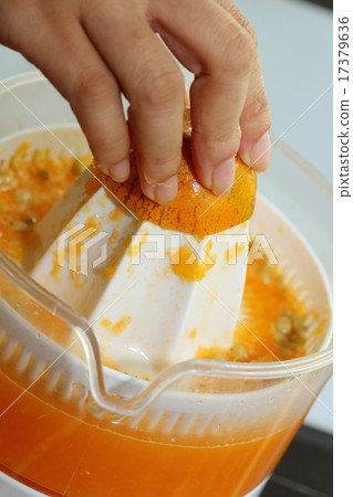 orange fruit squeezed with woman hand 17379636
