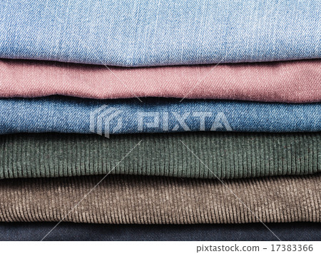stack of various jeans and corduroy slacks stack of various jeans and corduroy slacks 17383366
