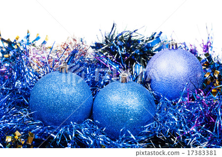 three blue Christmas balls and tinsel isolated 17383381